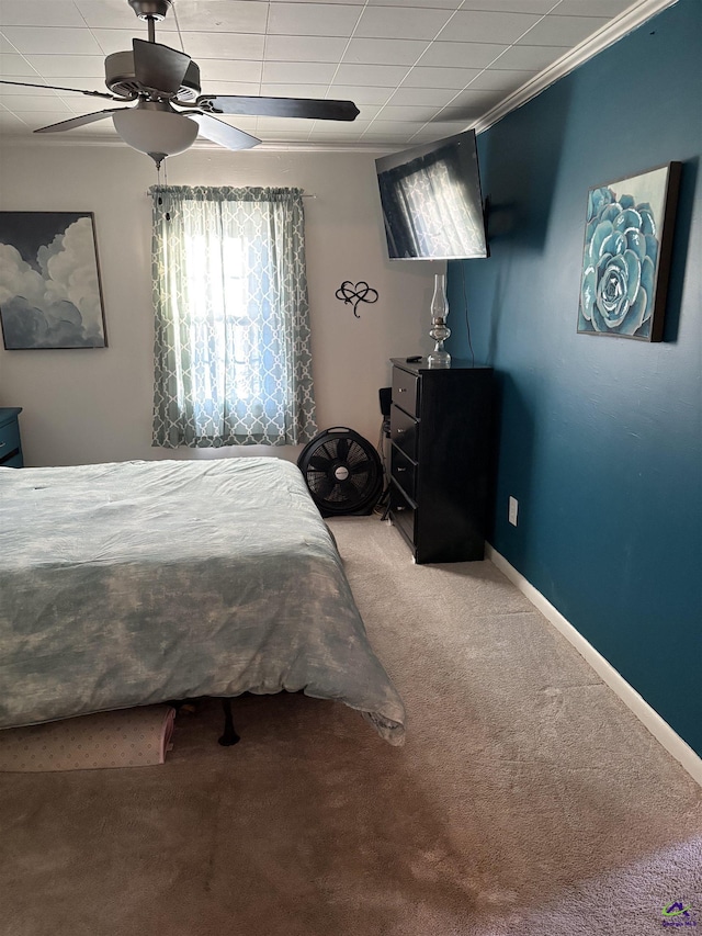 carpeted bedroom featuring a drop ceiling and ceiling fan