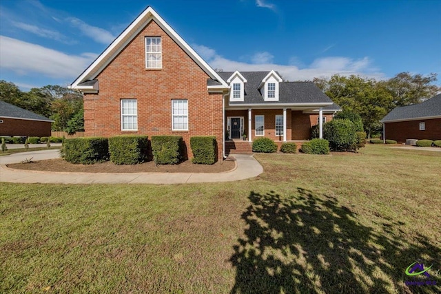 view of front property with covered porch and a front yard