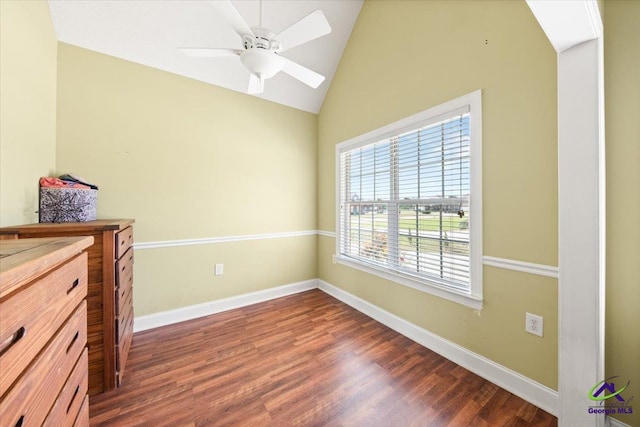 interior space featuring ceiling fan, dark wood-type flooring, and lofted ceiling