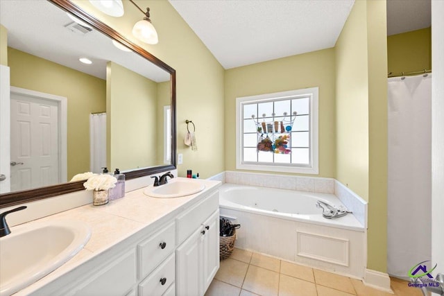 bathroom featuring tile patterned flooring, a textured ceiling, vanity, and a washtub