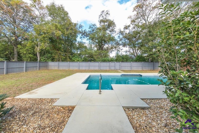 view of pool with a lawn and a patio area