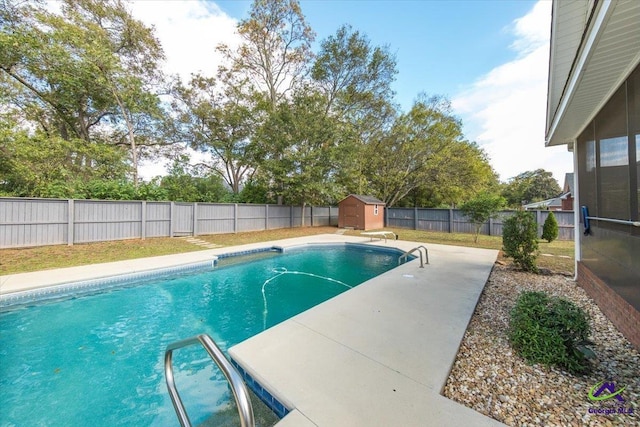 view of pool with a storage shed