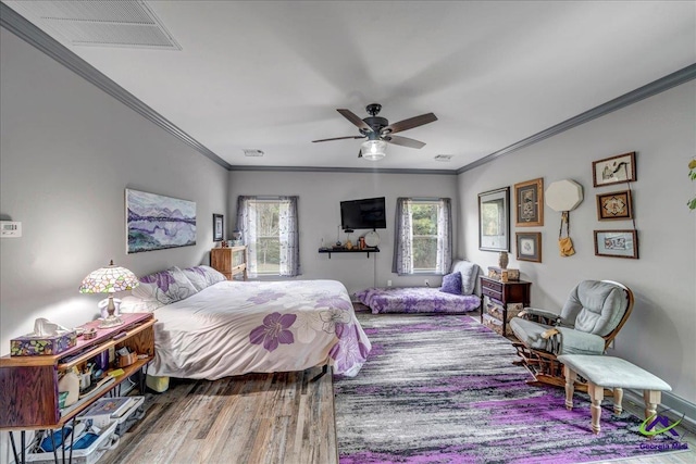 bedroom featuring wood-type flooring, ceiling fan, and crown molding