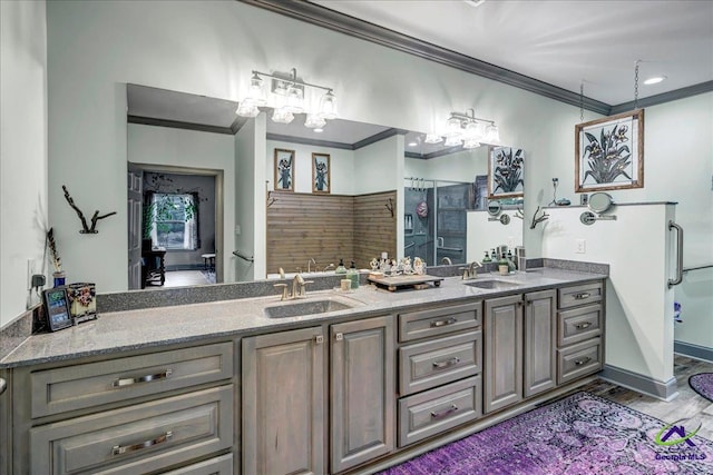 bathroom with hardwood / wood-style floors, a shower with shower door, ornamental molding, and vanity