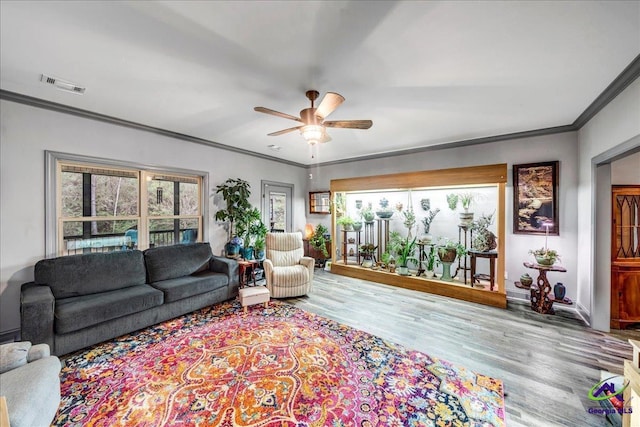 living room featuring ceiling fan, light hardwood / wood-style flooring, and ornamental molding