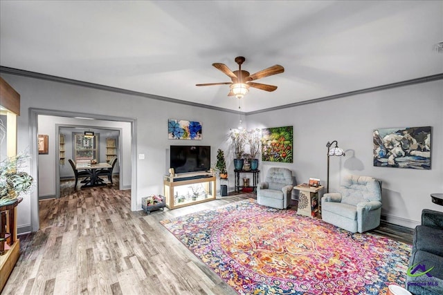 living room featuring crown molding, hardwood / wood-style floors, and ceiling fan