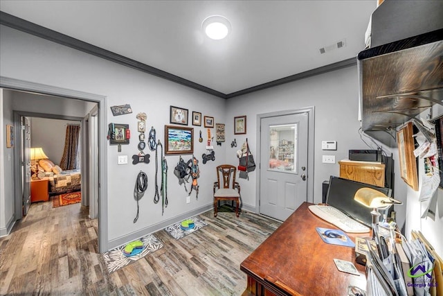 office featuring hardwood / wood-style flooring and crown molding