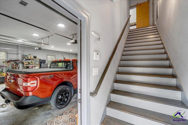 staircase featuring concrete flooring