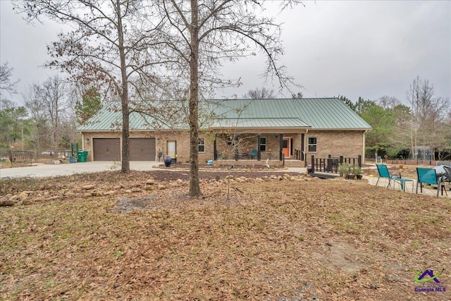 rear view of property featuring a porch and a garage