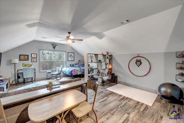 bedroom featuring ceiling fan, lofted ceiling, and hardwood / wood-style flooring