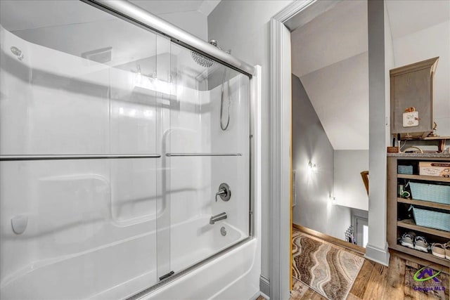 bathroom with shower / bath combination with glass door, lofted ceiling, and hardwood / wood-style flooring