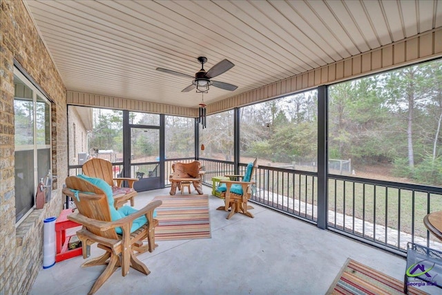 sunroom featuring ceiling fan