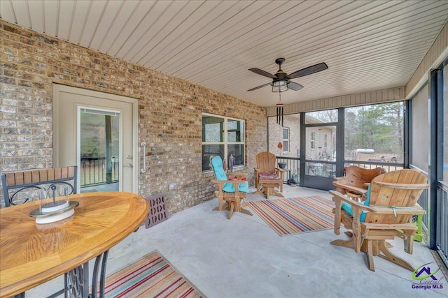 sunroom featuring ceiling fan