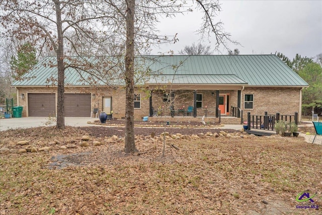 view of front of property with a porch and a garage