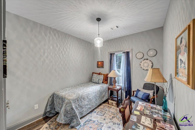 bedroom with wood-type flooring