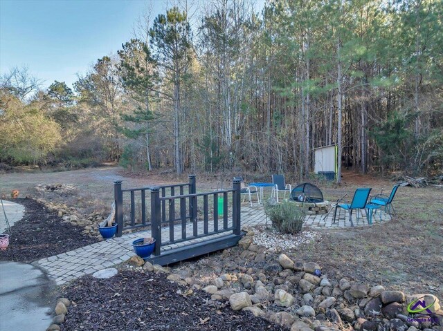 view of yard featuring an outdoor fire pit and a wooden deck