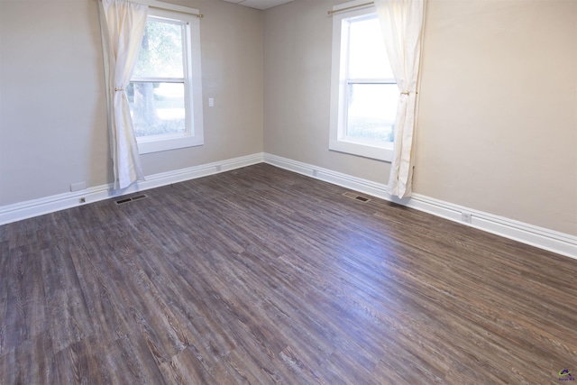 spare room with dark wood-type flooring