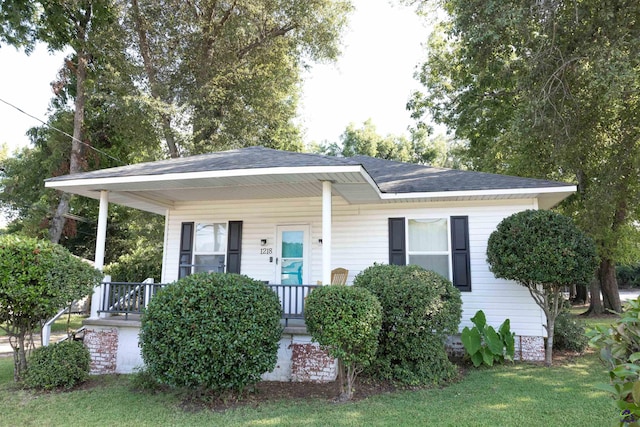 view of front of house with a front yard and a porch