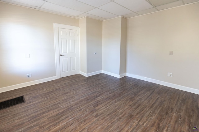 unfurnished room with a paneled ceiling and dark wood-type flooring