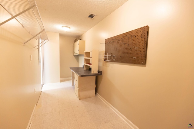 hallway featuring a textured ceiling