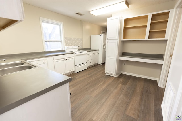 kitchen with white cabinetry, sink, dark hardwood / wood-style floors, and white appliances