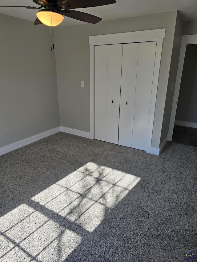 unfurnished bedroom with carpet, ceiling fan, and a closet