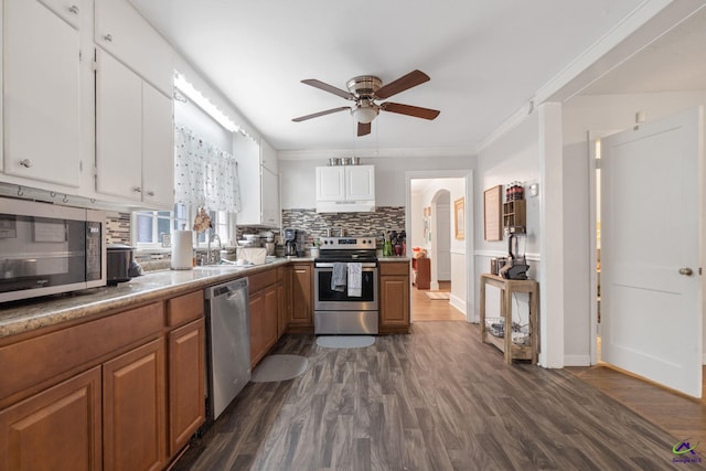 kitchen featuring white cabinetry, dark wood-type flooring, ceiling fan, and stainless steel appliances