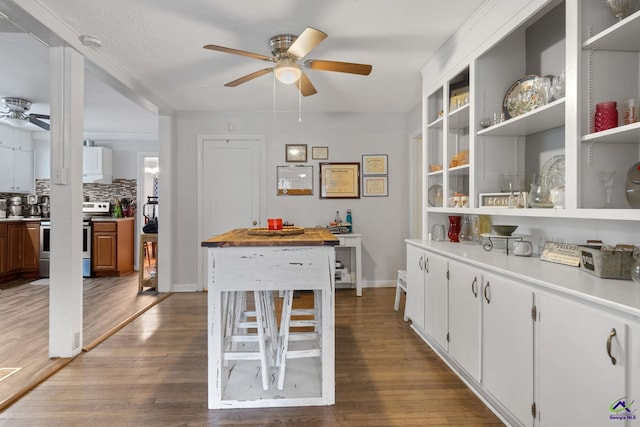 interior space with wood-type flooring and ceiling fan