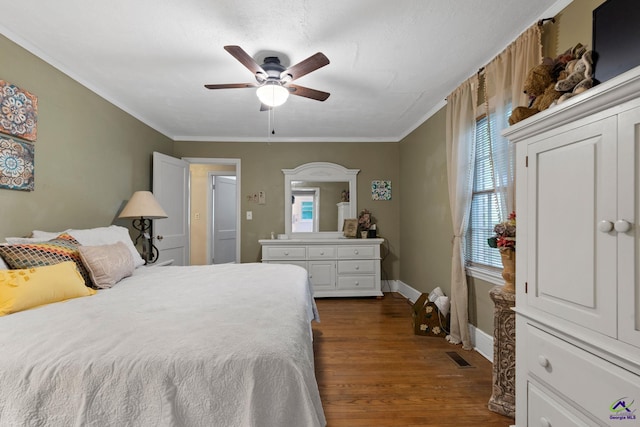 bedroom with ceiling fan, dark hardwood / wood-style flooring, and crown molding