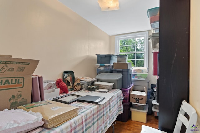 bedroom featuring wood-type flooring and vaulted ceiling