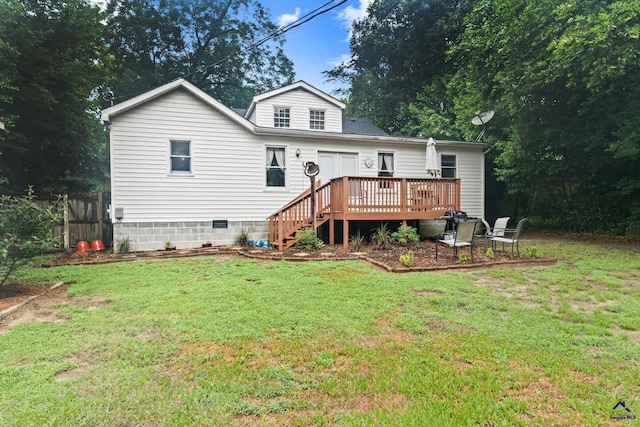 rear view of house featuring a lawn and a deck