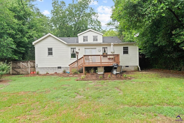 back of house featuring a yard and a wooden deck