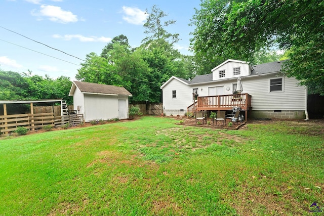 view of yard featuring a deck and a storage shed