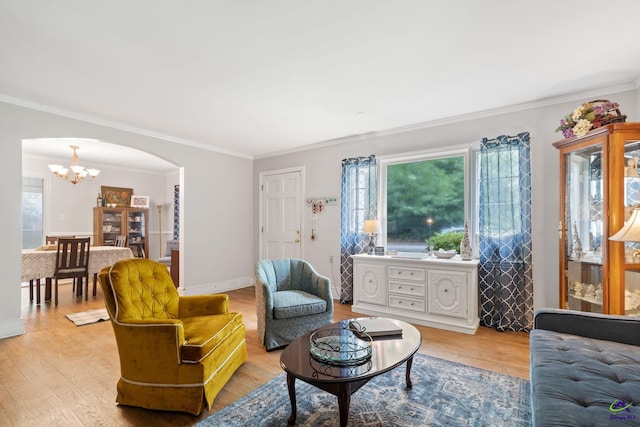 living room with crown molding, light hardwood / wood-style flooring, and a notable chandelier