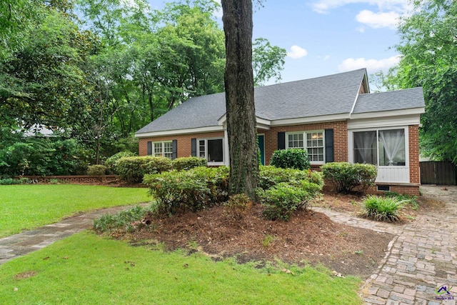 cape cod home featuring a front lawn