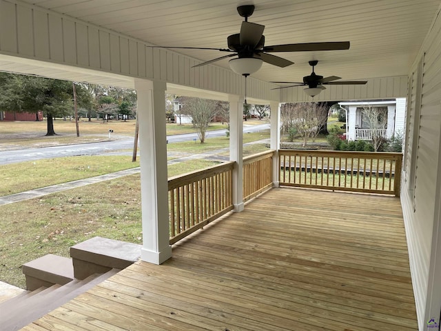 wooden terrace featuring covered porch and ceiling fan