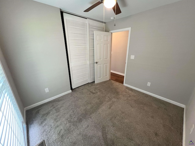 unfurnished bedroom with ceiling fan, a closet, and carpet