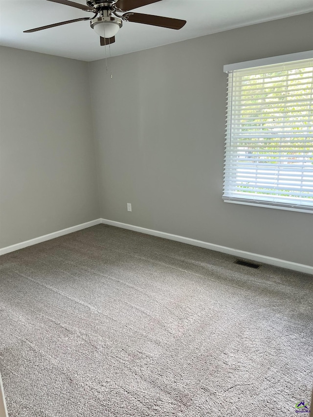 empty room featuring carpet floors and ceiling fan