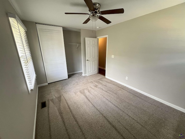 unfurnished bedroom featuring ceiling fan, carpet floors, and a closet