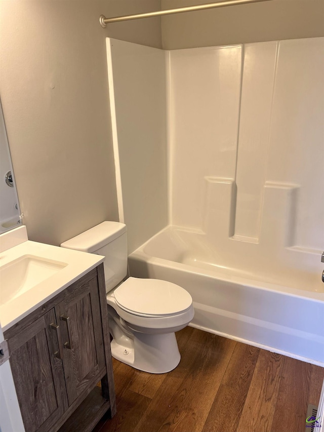 full bathroom featuring bathtub / shower combination, hardwood / wood-style floors, vanity, and toilet