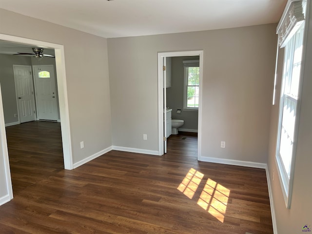 unfurnished room with dark hardwood / wood-style floors and ceiling fan