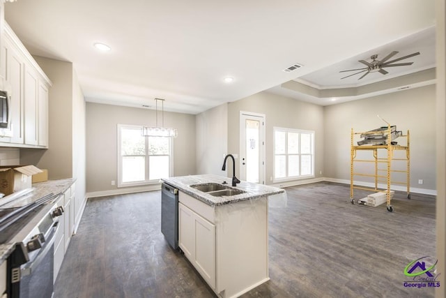 kitchen with sink, an island with sink, white cabinets, and appliances with stainless steel finishes