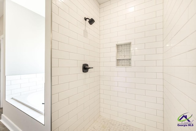 bathroom featuring shower with separate bathtub