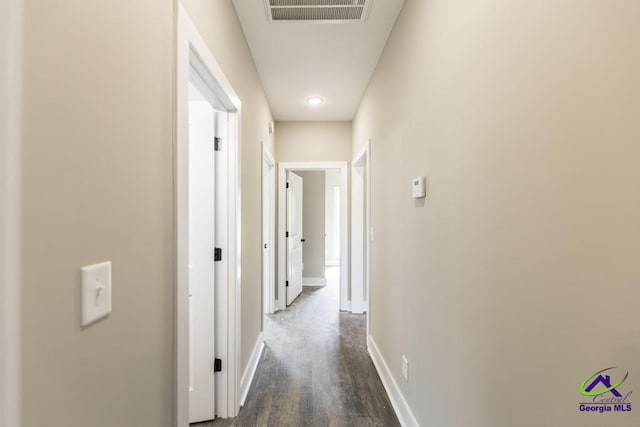 hallway with dark hardwood / wood-style flooring