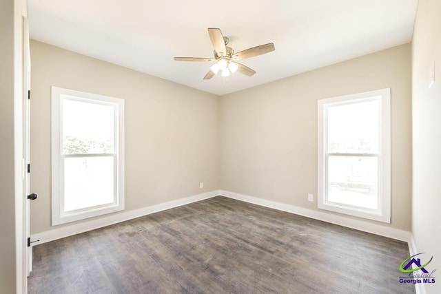 spare room featuring dark hardwood / wood-style flooring and ceiling fan