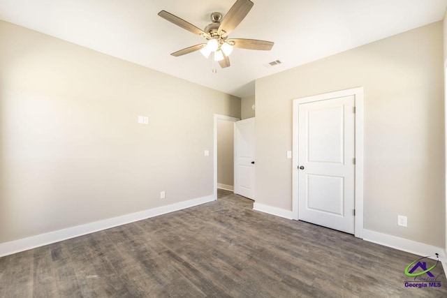 unfurnished bedroom featuring dark hardwood / wood-style floors and ceiling fan