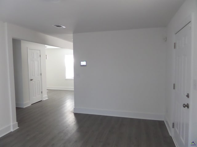 spare room with dark hardwood / wood-style floors