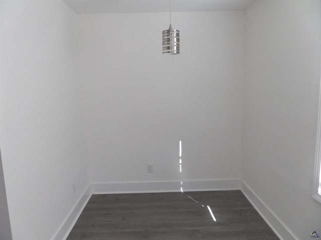 spare room featuring dark wood-type flooring