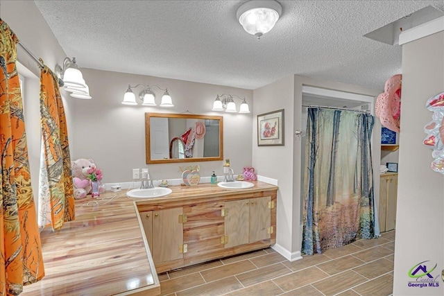 bathroom featuring vanity and a textured ceiling