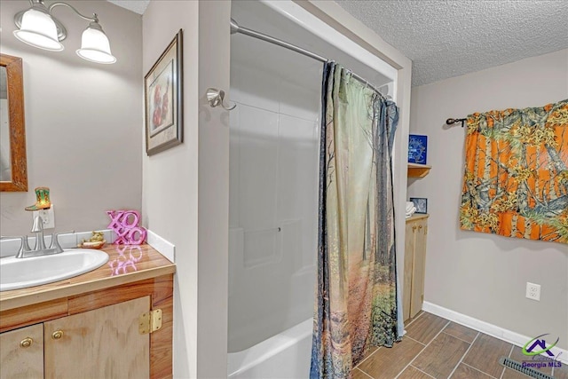 bathroom with vanity, a textured ceiling, and shower / bathtub combination with curtain